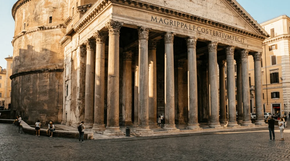 The massive Corinthian columns and entrance facade of the Pantheon in Rome
