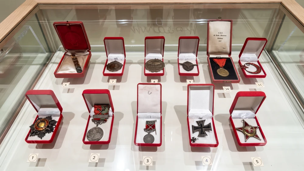 Müzedeki vitrinde kırmızı kutular içinde numaralı Atatürk madalyaları ve nişanları