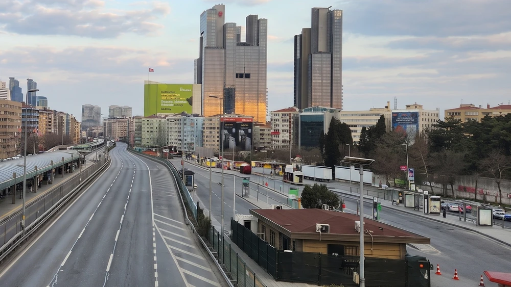Mecidiyeköy'de Metrobüs yolu, istasyon çatısı ve gün batımında ofis kuleleri